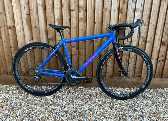 Blue Specialized road bike fitted with Planet X Pro Carbon wheels