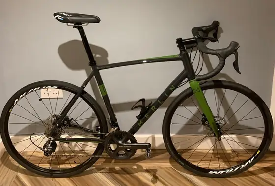 Black and green road bike prepared for winter riding